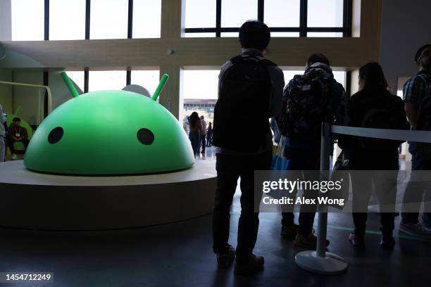 Attendees visit the Google booth where a model of the Android logo is on display at CES 2023 at the Las Vegas Convention Center on January 06, 2023...