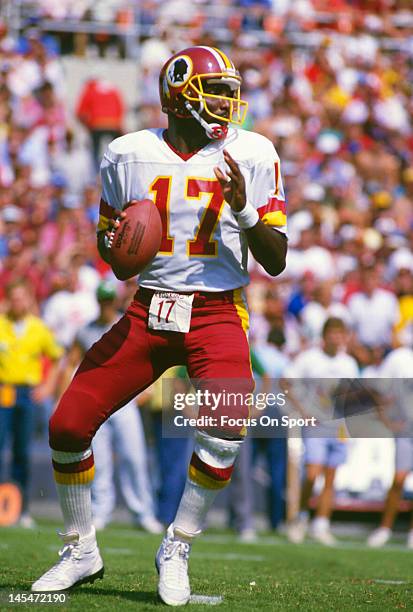 Washington, D.C. Quarterback Doug Williams of the Washington Redskins drops back to pass against the Philadelphia Eagles during an NFL football game...