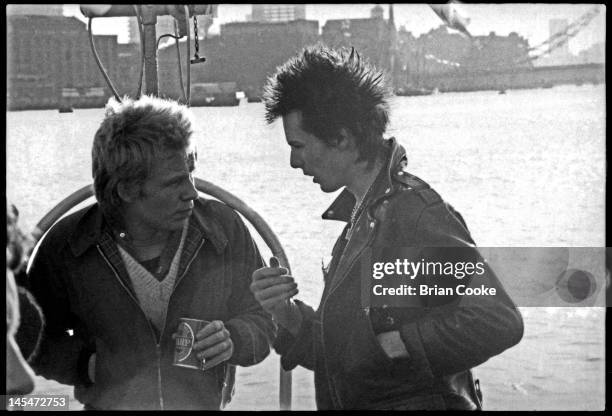 Paul Cook and Sid Vicious of English punk rock band the Sex Pistols aboard the Queen Elizabeth on the River Thames on June 7, 1977 during their...