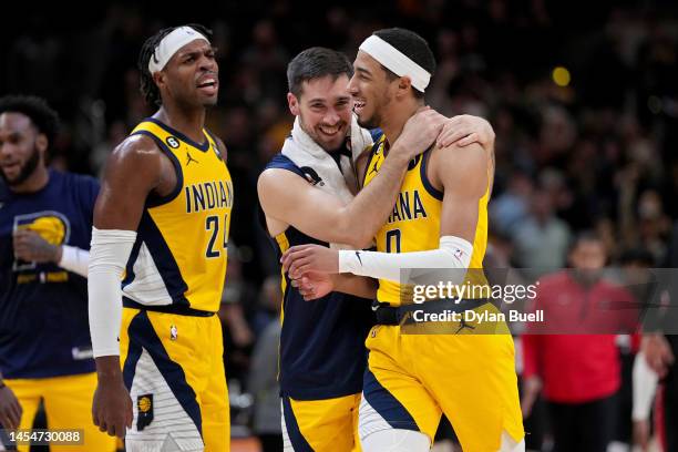 Buddy Hield, T.J. McConnell, and Tyrese Haliburton of the Indiana Pacers celebrate in the fourth quarter against the Portland Trail Blazers at...