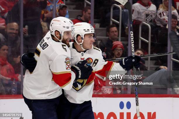 Aaron Ekblad of the Florida Panthers celebrates his third period goal with Anton Lundell while playing the Detroit Red Wings at Little Caesars Arena...