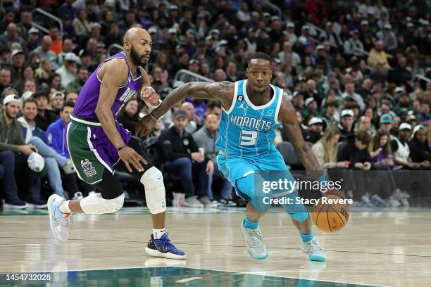 Terry Rozier of the Charlotte Hornets drives to the basket against Jevon Carter of the Milwaukee Bucks during the second half of a game at Fiserv...