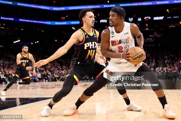 Jimmy Butler of the Miami Heat handles the ball against Landry Shamet of the Phoenix Suns during the first half of the NBA game at Footprint Center...