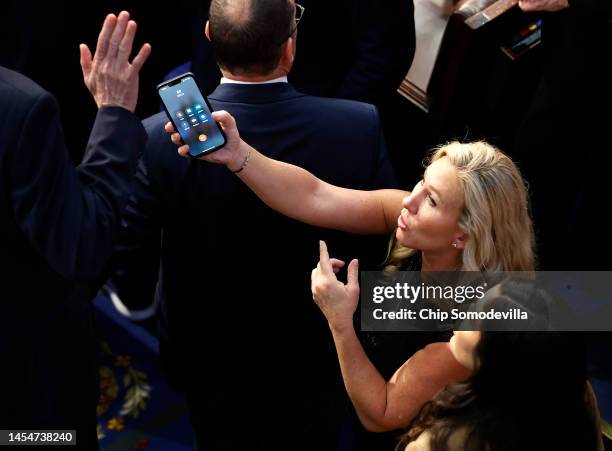 Rep.-elect Matt Rosendale refuses to talk with former President Donald Trump on a phone being offered by Rep.-elect Marjorie Taylor Greene during the...