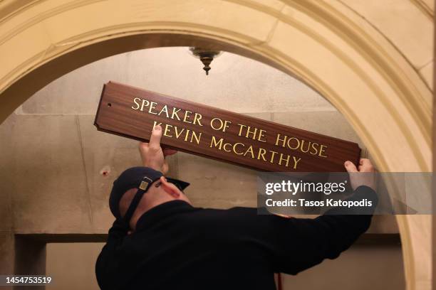 Worker replaces a sign over the office of U.S. Speaker of the House Kevin McCarthy after being elected as Speaker in the U.S. Capitol Building on...