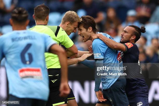 Nicholas Pennington of the Phoenix and Max Burgess of Sydney FC clash during the round 11 A-League Men's match between Sydney FC and Wellington...