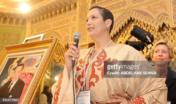 Morocco's Asma Chaabi, president for IWF Morocco, flanked by Chile's Monica Rubio, president of the International Women Forum , speaks during the...