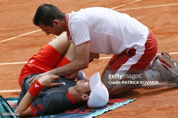 Britain's Andy Murray is treated after an injury as he plays against Finland's Jarkko Nieminen during their Men's Singles 2nd Round tennis match of...