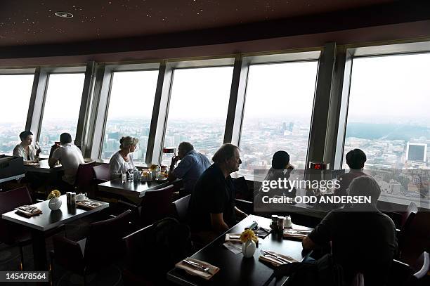 Breakfast guests enjoy the view from the rotating restaurant in the TV tower in Berlin on May 29, 2012. The 368m tall Alexander Platz landmark...