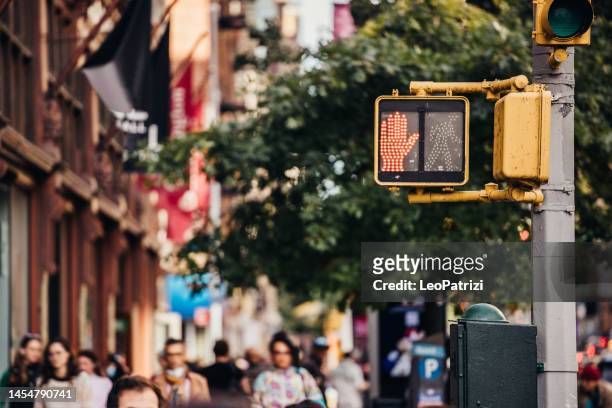 road intersection and red pedestrian crossing sign - pedestrian crossing sign stock pictures, royalty-free photos & images