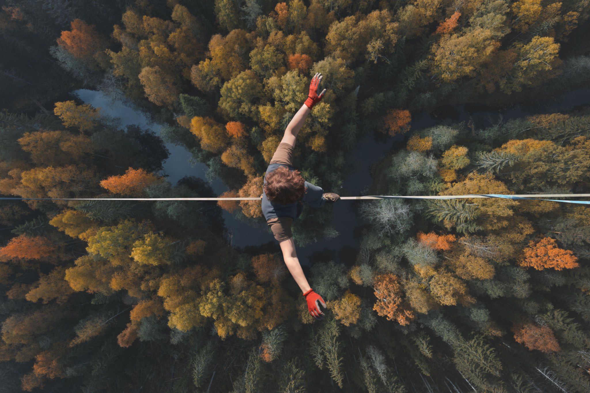 Highline over the forest. Rope walker walks on a rope at high altitude. Drone view. Slackline theme Highline over the forest. Rope walker walks on a rope at high altitude. Drone view. Slackline theme