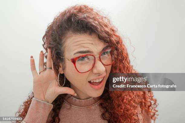 woman putting hand to her ear - not listening stock pictures, royalty-free photos & images