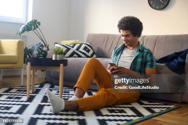 man using a mobile phone - sitting on ground stock pictures, royalty-free photos & images