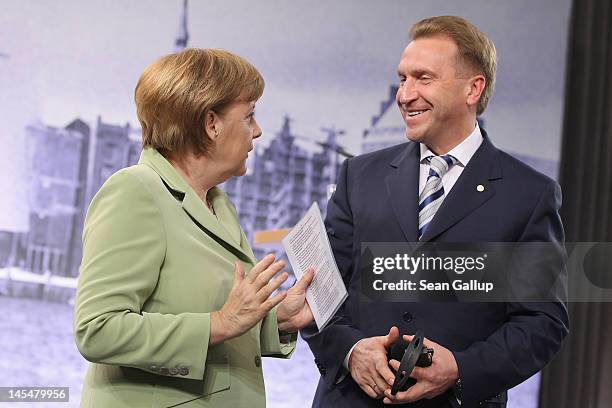 German Chancellor Angela Merkel speaks with Russian First Deputy Prime Minister Igor Shuvalov at the conclusion of the 2012 Council of Baltic Sea...