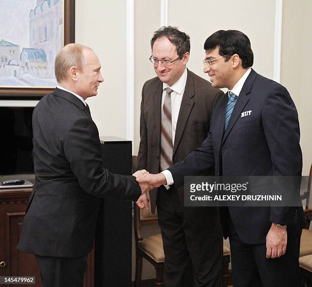 Russian President Vladimir Putin shakes hands with World chess champion Viswanathan Anand and of India and Israeli grandmaster Boris Gelfand during...