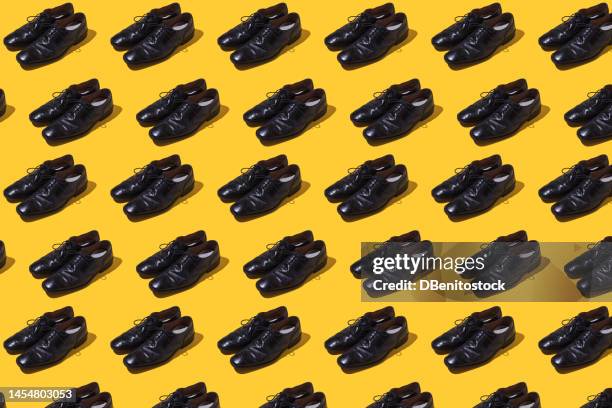 pattern of pairs of vintage black leather shoes on a yellow background. concept of elegance, party, well dressed, shoe, footwear and man. - formal footwear stock pictures, royalty-free photos & images