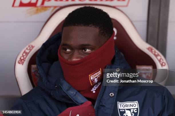 Brian Bayeye of Torino FC looks on from the bench prior to the Friendly match between Torino FC and US Cremonese at Stadio Olimpico Grande Torino on...