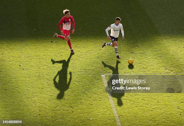 Ben Woodburn of Preston is pursued by Jack Rudoni of Huddersfield during the Emirates FA Cup Third Round match between Preston North End and...