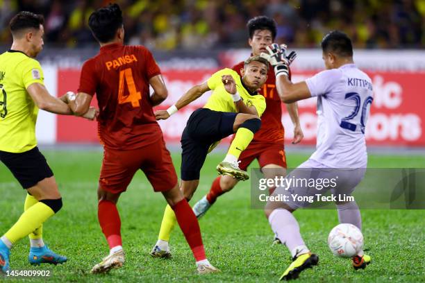 Faisal Halim of Malaysia scores the team's first goal past Kittipong Phoothawchuek of Thailand in the first half during the AFF Mitsubishi Electric...
