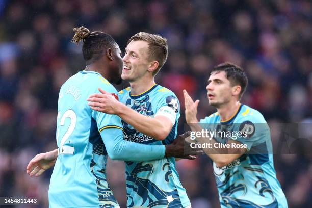 James Ward-Prowse of Southampton celebrates with teammates Mohammed Salisu and Romain Perraud after scoring the team's first goal during the Emirates...