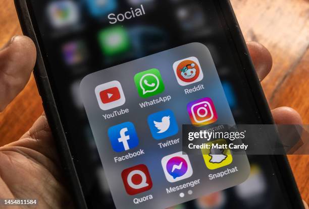 In this photo illustration the logo of US online social media and social networking service Twitter is displayed on a smartphone screen on January...