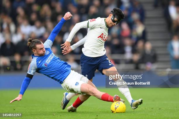 Son Heung-Min of Tottenham Hotspur is challenged by Ryan Tunnicliffe of Portsmouth during the Emirates FA Cup Third Round match between Tottenham...