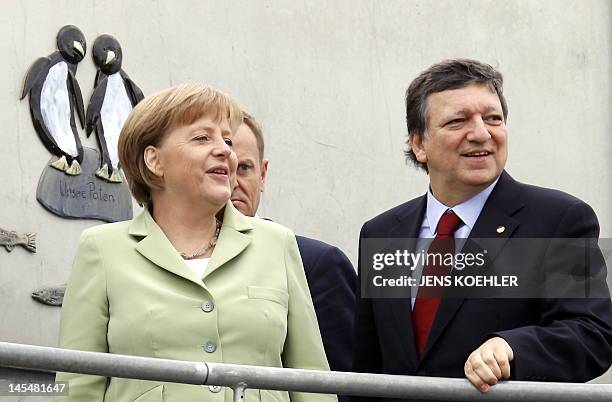 European Commission President Jose Manuel Barroso and German chancellor Angela Merkel arrive to feed penguins at the Oceaneum during the Baltic Sea...