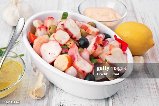 octopus, prawn and vegetable salad in a white earthenware casserole dish - seafood salad stock pictures, royalty-free photos & images