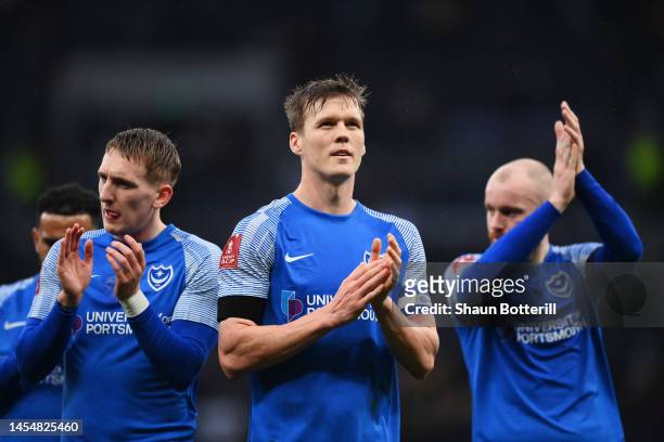 Sean Raggett of Portsmouth and teammates acknowledge the fans following during the Emirates FA Cup Third Round match between Tottenham Hotspur and...