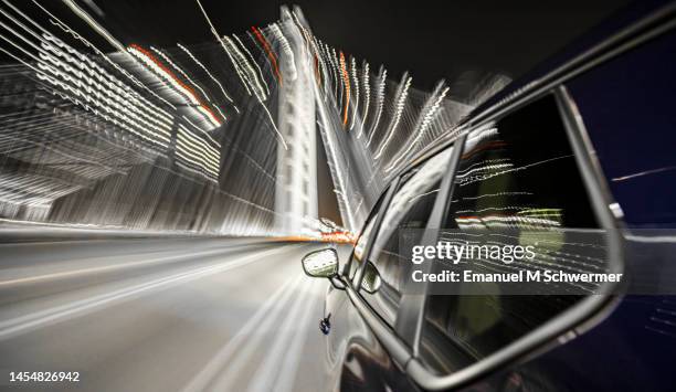 futuristic electric car drives over the modern bay bridge of san francisco. - futuristic car stock-fotos und bilder