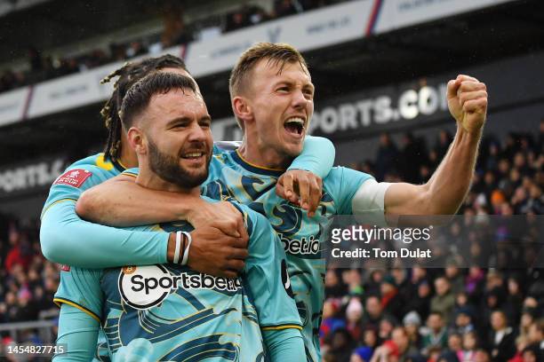 Adam Armstrong of Southampton celebrates with James Ward-Prowse and teammates after scoring the team's second goal during the Emirates FA Cup Third...