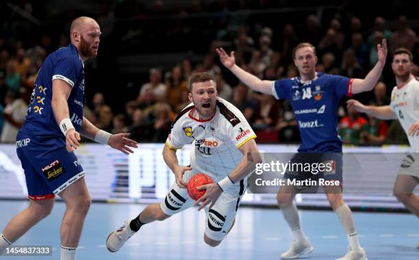 Philipp Weber of Germany challenges Arnar Arnarsson of Iceland during the handball international friendly match between Germany and Iceland at...