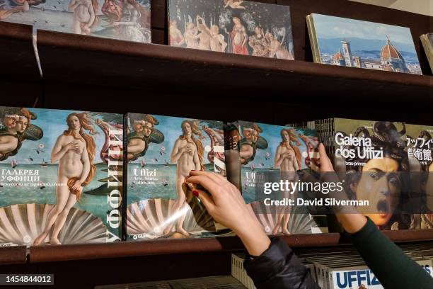 Visitors shop for souvenirs, showing the iconic painting The Birth of Venus by the 15th century Italian Renaissance artist Sandro Botticelli, at the...