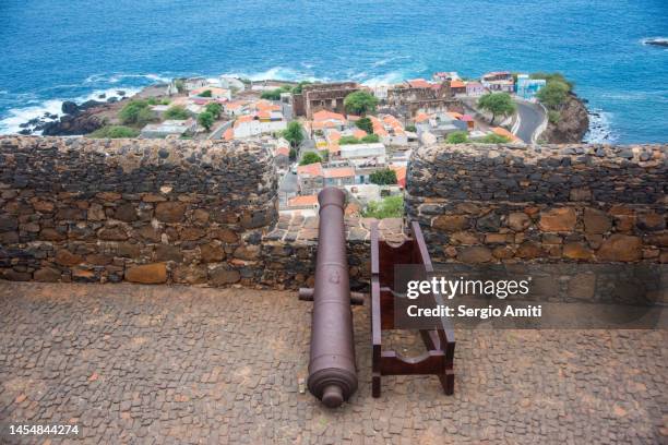 french cannon on ramparts of royal fortress of san felipe and cidade velha on santiago island, cape verde. - fort san felipe stock pictures, royalty-free photos & images