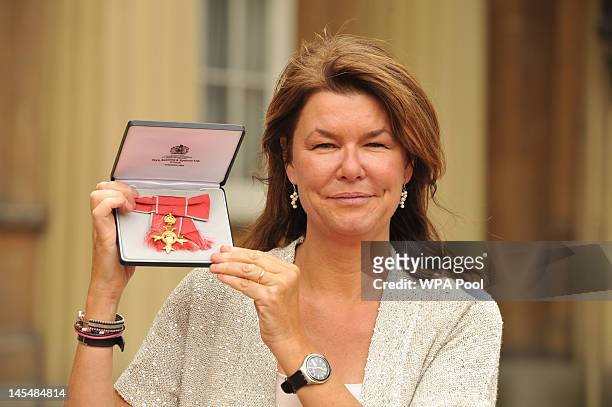 Sky News Special Correspondent Alex Crawford poses with her Officer of the British Empire medal presented to her by Queen Elizabeth II during a...