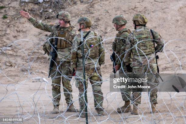 Texas National Guard soldiers stand guard at the U.S.-Mexico border on January 07, 2023 as viewed from Ciudad Juarez, Mexico. U.S. President Joe...