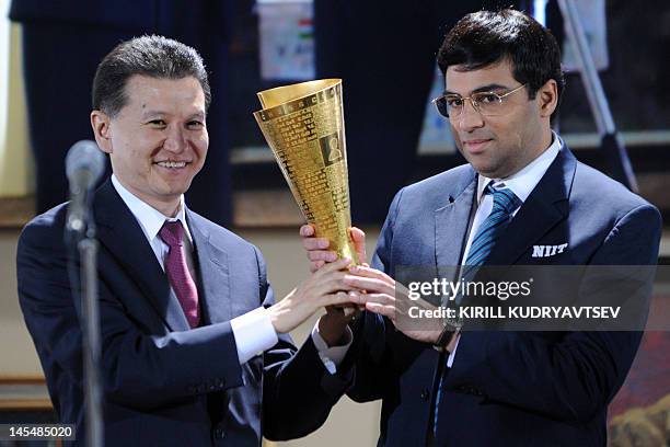 India's defending World chess champion Viswanathan Anand receives an award from International Chess Federation President Kirsan Ilyumzhinov during...