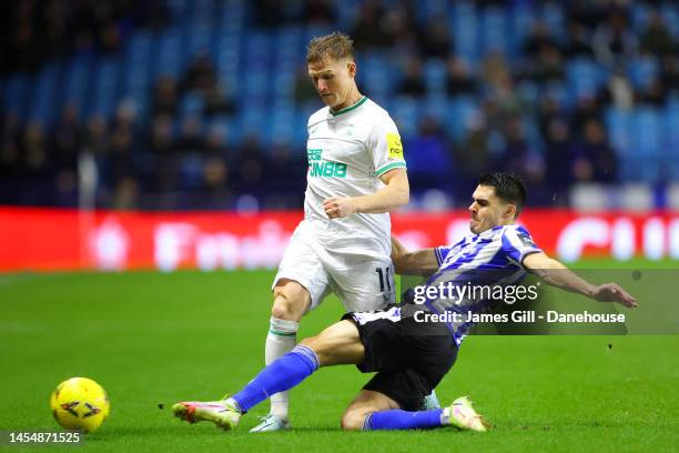 Matt Ritchie of Newcastle United is tackled by Reece James of Sheffield Wednesday during the Emirates FA Cup Third Round match between Sheffield...