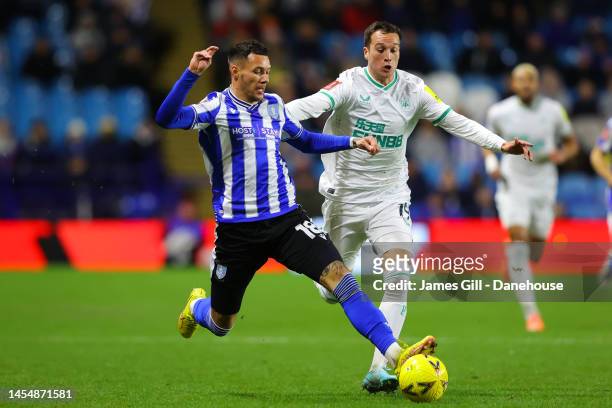 Marvin Johnson of Sheffield Wednesday battles for possession with Javi Manquillo of Newcastle United during the Emirates FA Cup Third Round match...