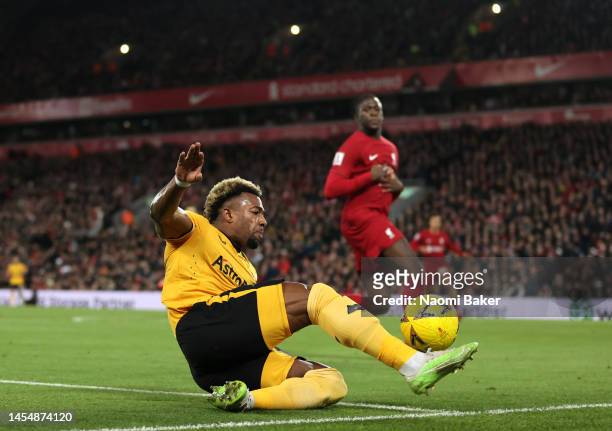 Adama Traore of Wolverhampton Wanderers stretches to keep the ball in play during the Emirates FA Cup Third Round match between Liverpool FC and...
