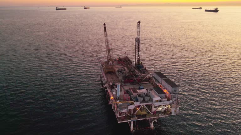 Cargo Rigs Brightly Lit OffShore Oil and Gas Drilling Rig with Cargo Ships in ...