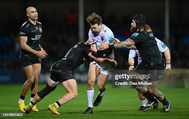 James Ramm of Northampton Saints is tackled by Sam Simmonds and Harry Williams of Exeter Chiefs during the Gallagher Premiership Rugby match between...