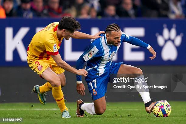 Miguel Gutierrez of Girona FC compete for the ball with Martin Braithwaite of RCD Espanyol during the LaLiga Santander match between RCD Espanyol and...