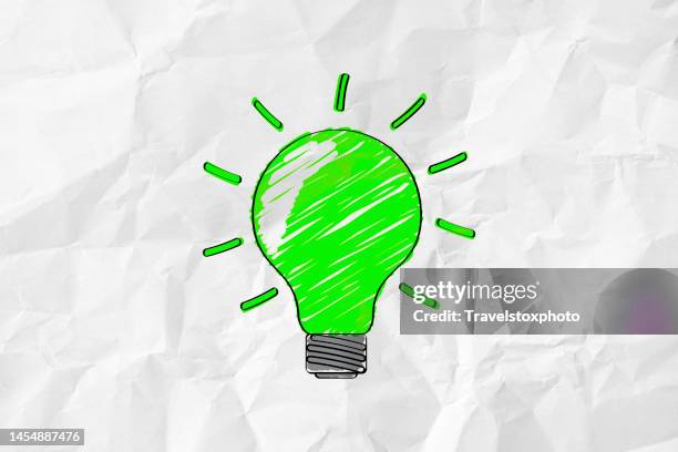green glowing light bulb. ideas for more sustainability. green innovations. environmentally friendly innovation. sketch drawing style on paper. use and production of green clean energy. green business idea. - resourceful bildbanksfoton och bilder