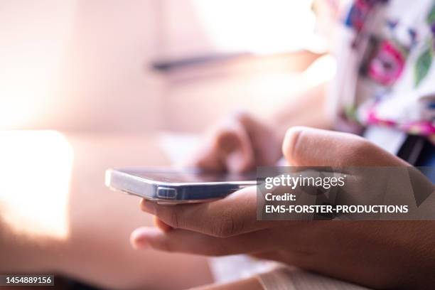 close up of teenager boy hand is using smartphone in airplane - youth crime stock pictures, royalty-free photos & images