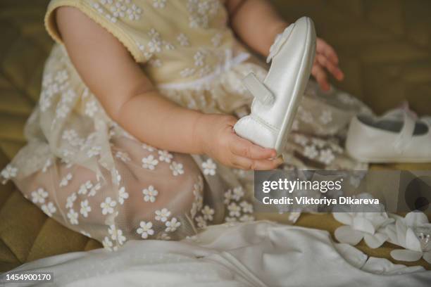 child puts on shoes - baptism girl stock pictures, royalty-free photos & images