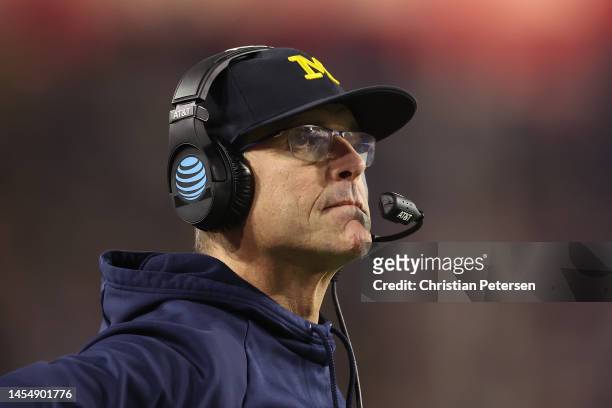 Head coach Jim Harbaugh of the Michigan Wolverines looks on during the Vrbo Fiesta Bowl at State Farm Stadium on December 31, 2022 in Glendale,...
