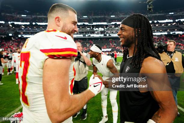 Travis Kelce of the Kansas City Chiefs and Davante Adams of the Las Vegas Raiders meet on the field after their game at Allegiant Stadium on January...