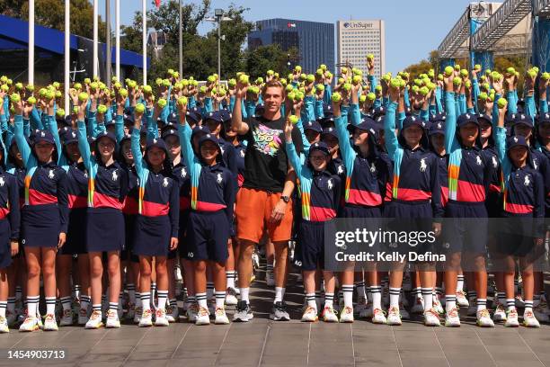 Denis Shapovalov of Canada poses with 2023 Australian Open ballkids during a media opportunity ahead of the 2023 Australian Open at Melbourne Park on...