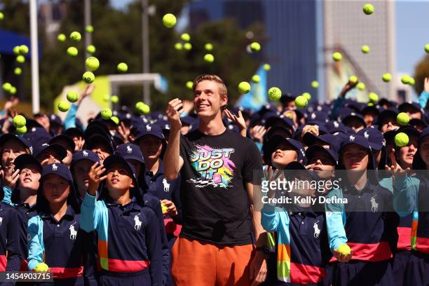 Denis Shapovalov of Canada poses with 2023 Australian Open ballkids during a media opportunity ahead of the 2023 Australian Open at Melbourne Park on...